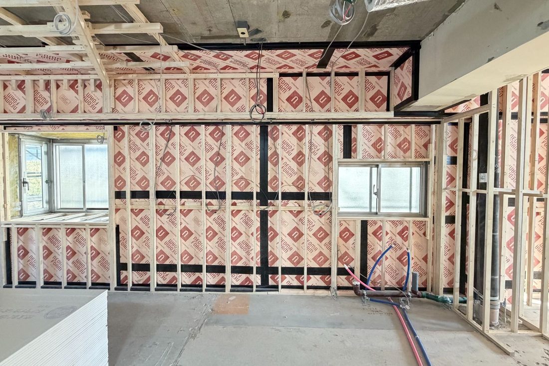 A wall under construction, with insulation fitted